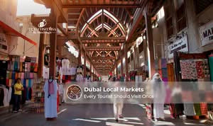Visitors exploring Dubai's vibrant local markets filled with spices, gold, textiles, and traditional souvenirs.